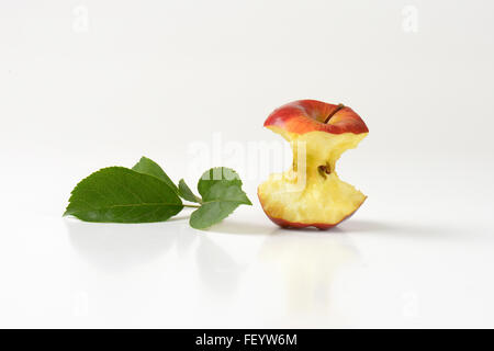 apple core and leaves on white background Stock Photo