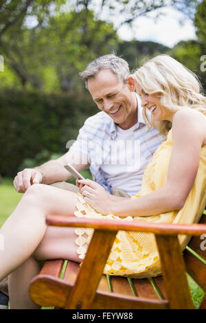 Happy couple sitting on a bench Stock Photo