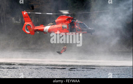 A U.S. Coast Guardsmen drops into waters during extraction training as part of Disaster Management Exchange 2015 at Joint Base Lewis-McChord, Wash., Nov. 20, 2015. The Disaster Management Exchange is an annual conference designed to strengthen collective disaster response coordination between U.S. and Chinese military forces. ( Sgt. 1st Class Andrew Porch) Stock Photo