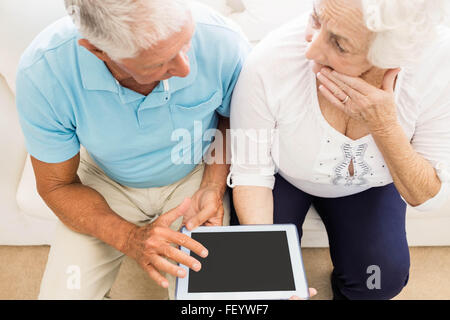 Focused senior couple using tablet Stock Photo