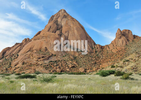 Greater Spitzkoppe, Namibia with grass field in the foreground Stock Photo