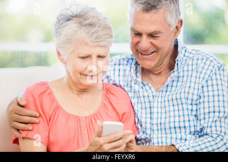 Smiling senior couple using smartphone Stock Photo