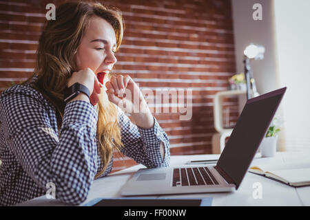 Young hipster businesswoman yawning Stock Photo