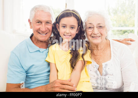 Grandparents smiling with their granddaughter Stock Photo