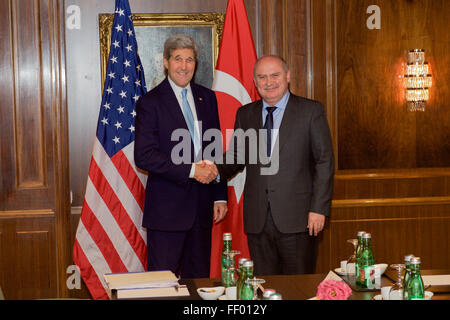 Secretary Kerry Shakes Hands With Turkish Foreign Minister Sinirlioglu Before Bilateral Meeting in Austria Focused on Syria Stock Photo