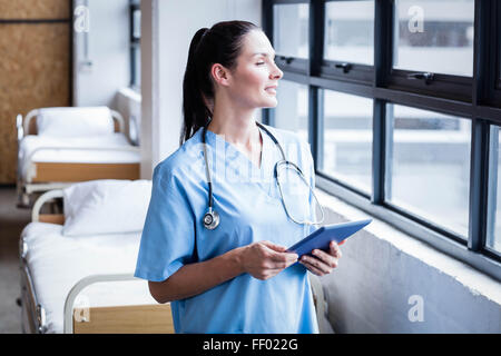 Nurse using her tablet pc Stock Photo