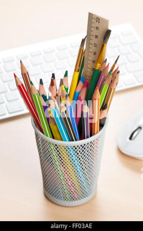 Colorful pencils in holder on office desk Stock Photo