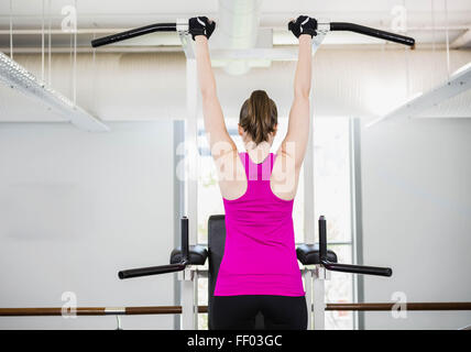 Fit woman doing pull up Stock Photo