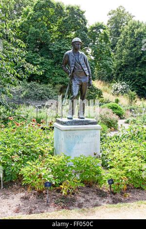 Bronze statue of a young man with a shovel entitled Out in the Fields by Arthur G. Atkinson Kew Botanic Gardens London England Stock Photo