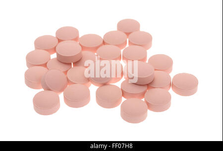 A group of pink famotidine tablets isolated on a white background. Stock Photo