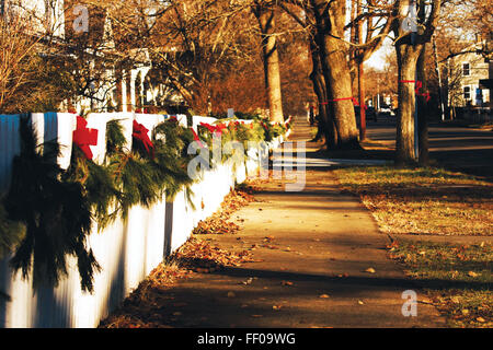 Suburban Sidewalk with Red Ribbons on Fence Suburban Sidewalk with Red Ribbons on Fence Stock Photo