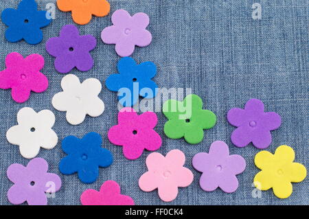 colorful artificial flowers on denim background Stock Photo