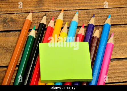 Empty notes with colorful pencils on wooden table Stock Photo
