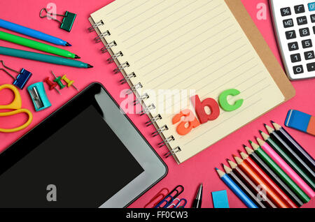 School objects and digital tablet on table Stock Photo