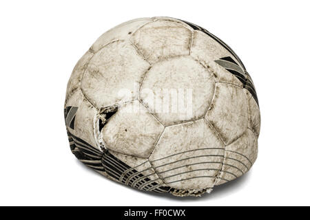 Old torn soccer ball, isolated on white background Stock Photo