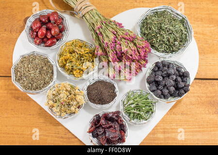bunches of various raw herbal tea in a heart shape Stock Photo