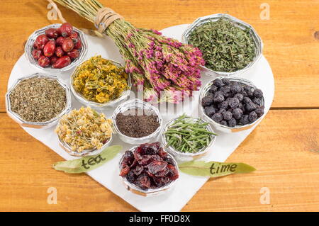 bunches of various raw herbal tea in a heart shape Stock Photo