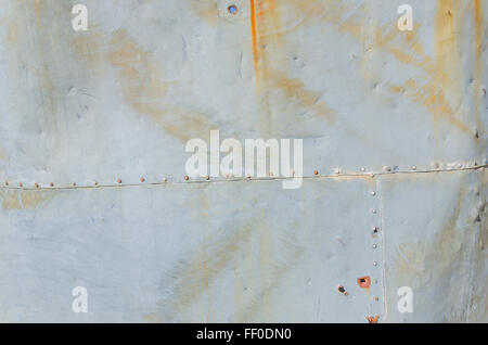 Rusted rivets in sheet metal of water tank at old mill Stock Photo