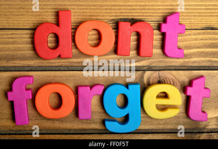 Colorful Don't Forget word on wooden table Stock Photo
