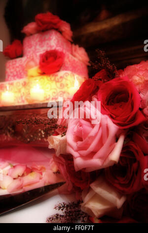 A wedding cake and bridal bouquet at a wedding reception. Stock Photo