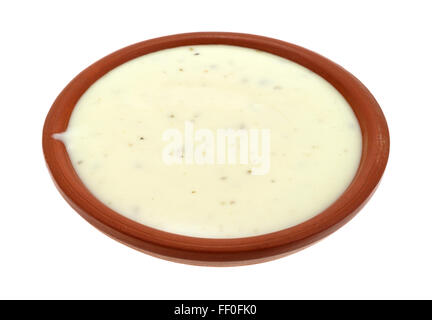 Side view of a small bowl of ranch dressing isolated on a white background. Stock Photo