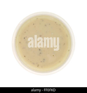 Top view of a small plastic container of ranch dressing isolated on a white background. Stock Photo