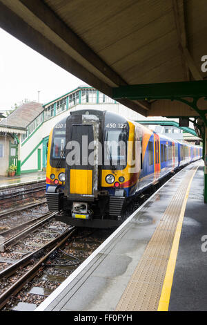 Class 450 Electric Multiple Unit (EMU) at Alton station, Hampshire on a wet day in August. Stock Photo