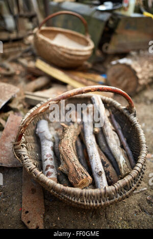 Basket with firewood outdoor in the countryside Stock Photo