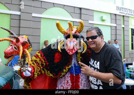 Traditional masked cultural figure VEJIGANTE posing with people during carnival. Ponce, Puerto Rico. February 2016 Stock Photo