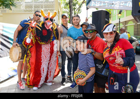Traditional masked cultural figure VEJIGANTE posing with people during carnival. Ponce, Puerto Rico. February 2016 Stock Photo
