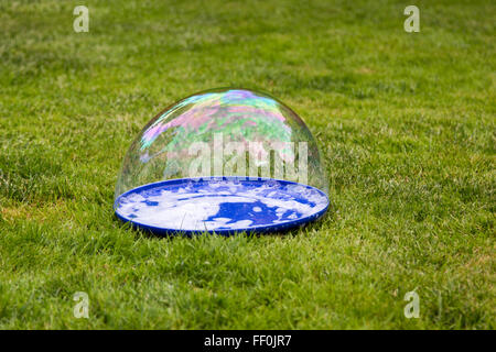 big bubble lies on a plate on the grass Stock Photo