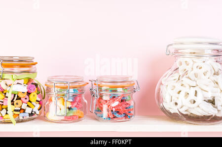 Colorful candies in jars on shelf. Stock Photo