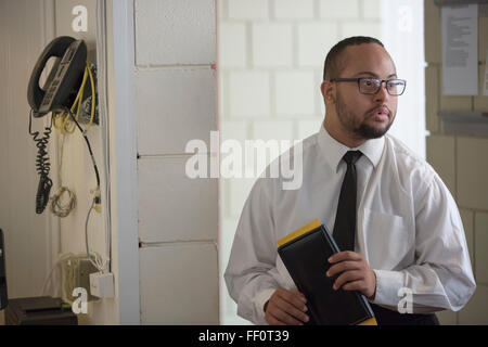 Mixed race server working in restaurant Stock Photo