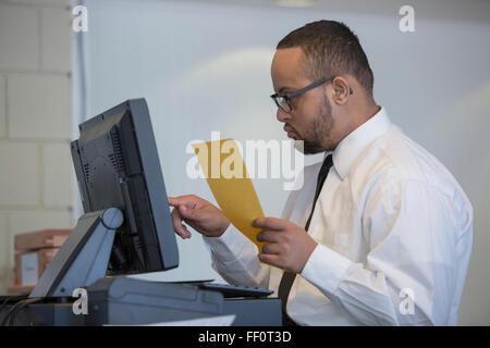 Mixed race server with down syndrome entering order in restaurant Stock Photo
