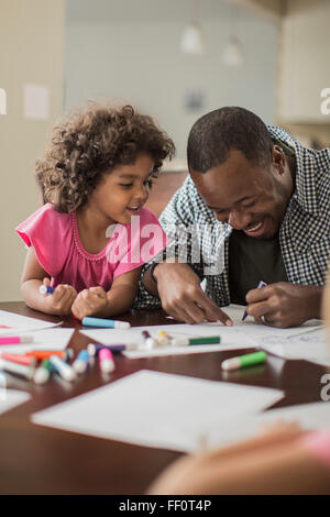 Father and daughter drawing in kitchen Stock Photo