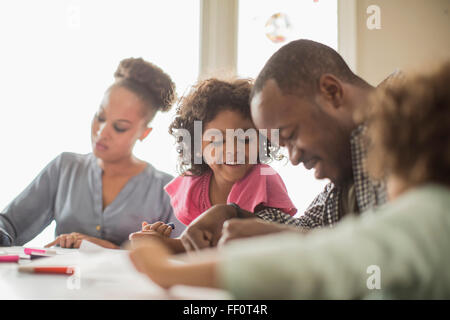 Family drawing together in kitchen Stock Photo