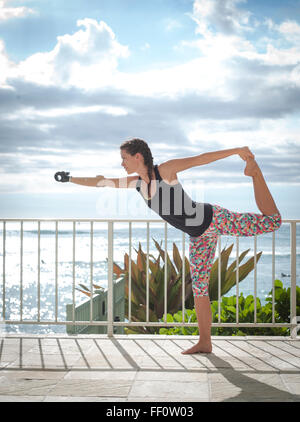 Mixed race amputee athlete stretching on balcony Stock Photo