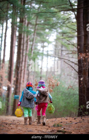 Caucasian girls walking in forest Stock Photo