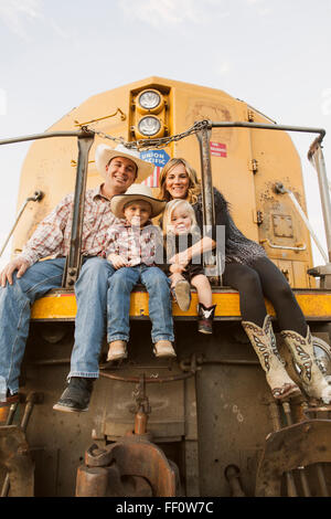 Family sitting on vintage train Stock Photo