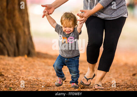 Caucasian mother and daughter walking outdoors Stock Photo