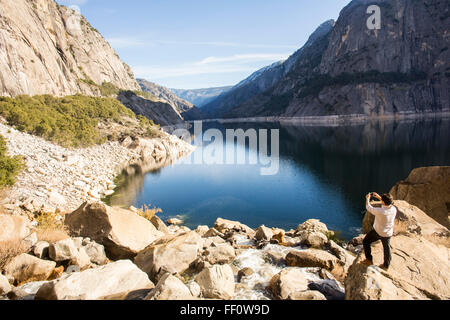 Caucasian man photographing lake in Yosemite National Park, California, United States Stock Photo