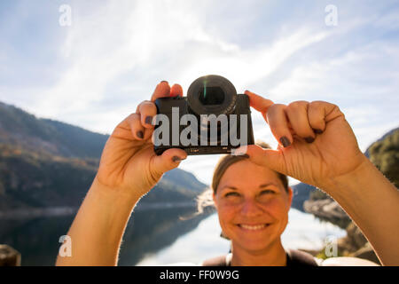 Caucasian woman photographing in Yosemite National Park, California, United States Stock Photo