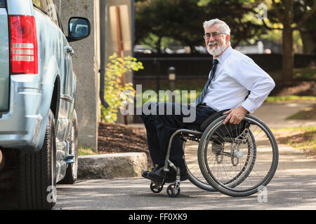 Caucasian businessman in wheelchair at van Stock Photo