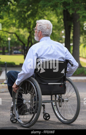 Caucasian businessman in wheelchair outdoors Stock Photo
