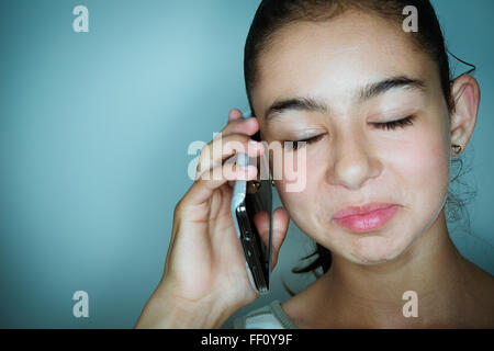 Mixed race girl talking on cell phone Stock Photo