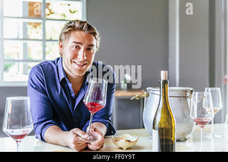 Caucasian man drinking wine in restaurant Stock Photo