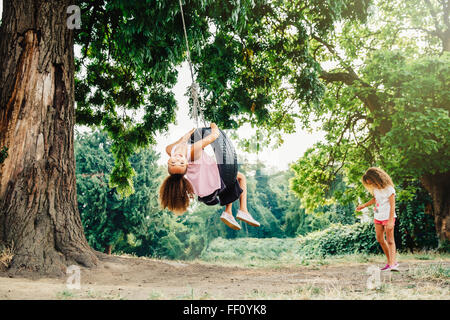 Mixed race sisters playing in backyard Stock Photo