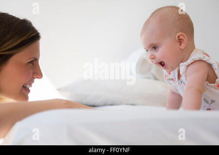 Caucasian mother and baby daughter playing Stock Photo