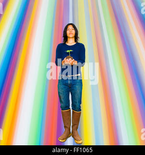 Japanese gardener holding plant Stock Photo