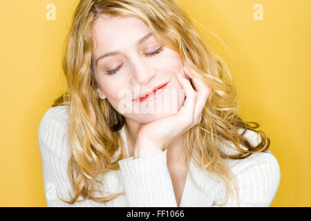 Smiling woman resting chin in hand Stock Photo